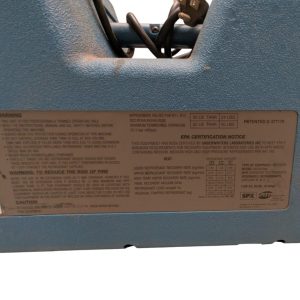 Label on a blue industrial unit showing warnings, specs, and certification information for refrigerant and operation.