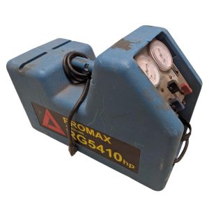 Blue portable pressure-testing unit with two gauges and attached cables, dusty from use.