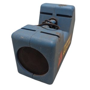 Blue vintage portable speaker with a round front speaker grille and dusty plastic casing, on white background.