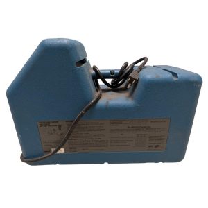 Blue portable refrigerant recovery machine with a coiled power cord on top and a labeled back panel showing setup diagram signature text.