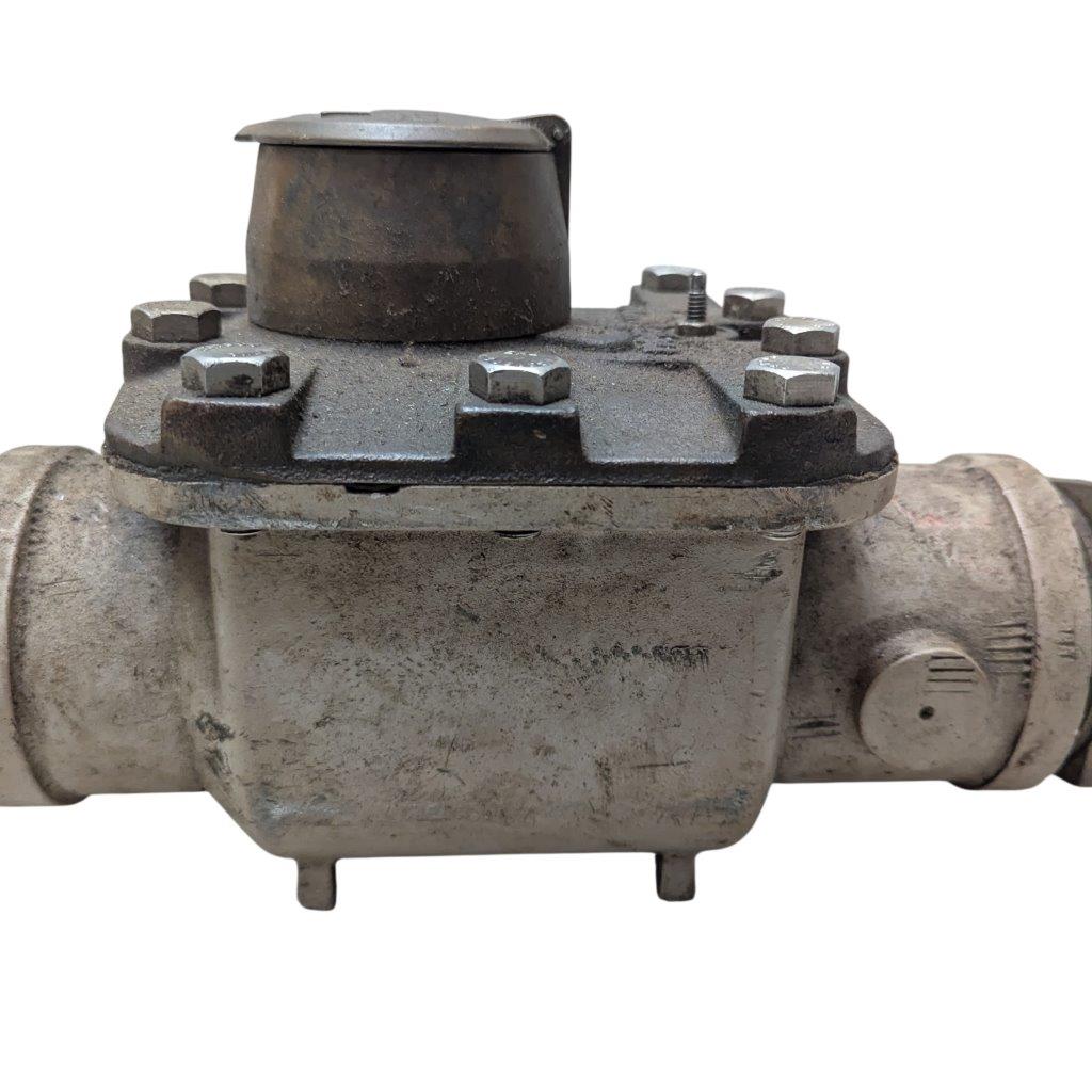 Neptune-3-FH-trident-turbine-awwa-class-II_10 | Chicago HVAC tools and supplies Industrial pipe valve with a bolted flanged connection and a rusted, dusty surface, likely used to regulate flow in a pipeline, cap on top of the actuator.