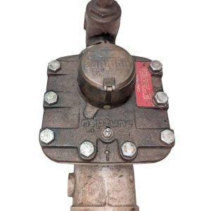 Neptune-3-FH-trident-turbine-awwa-class-II_15 | Chicago HVAC tools and supplies Gas shut-off valve on a rusted metal pipe, featuring a round access cap and bolt-down flange with a red caution label nearby.