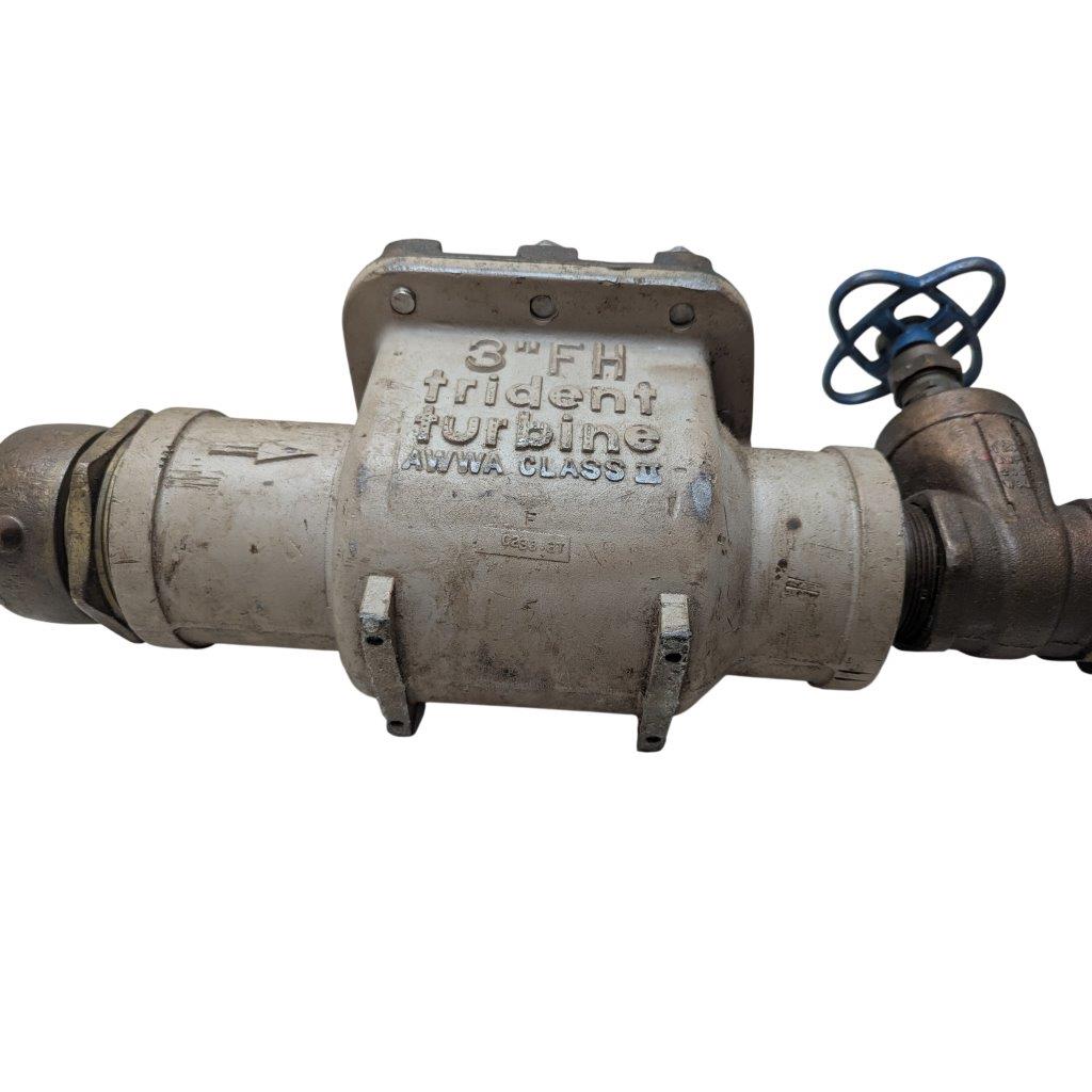 Neptune-3-FH-trident-turbine-awwa-class-II_17 | Chicago HVAC tools and supplies Industrial pipe valve with a blue handwheel on the right, used to regulate fluid flow in a piping system.