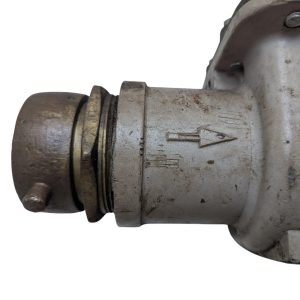 Neptune-3-FH-trident-turbine-awwa-class-II_19 | Chicago HVAC tools and supplies Metal pipe fitting/valve with an embossed arrow indicating flow direction; dirty, worn surface.