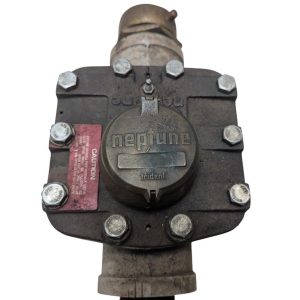 Neptune-3-FH-trident-turbine-awwa-class-II_3 | Chicago HVAC tools and supplies Close-up of an industrial gas valve with a round Neptune cap and bolted flange, used for pipeline control in facilities.