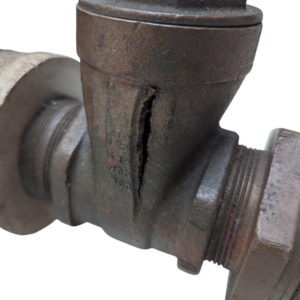Neptune-3-FH-trident-turbine-awwa-class-II_7 | Chicago HVAC tools and supplies Rusty metal T-joint with a large vertical crack, indicating a damaged pipe connection.