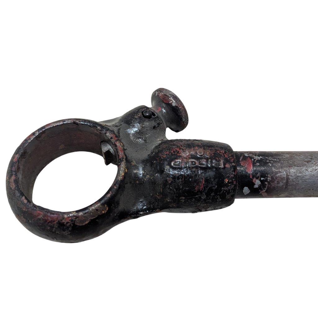 RIDGID-00-R_2 | Chicago HVAC tools and supplies Rusty black metal clamp with a circular ring at the end, mounted on a metal tube.