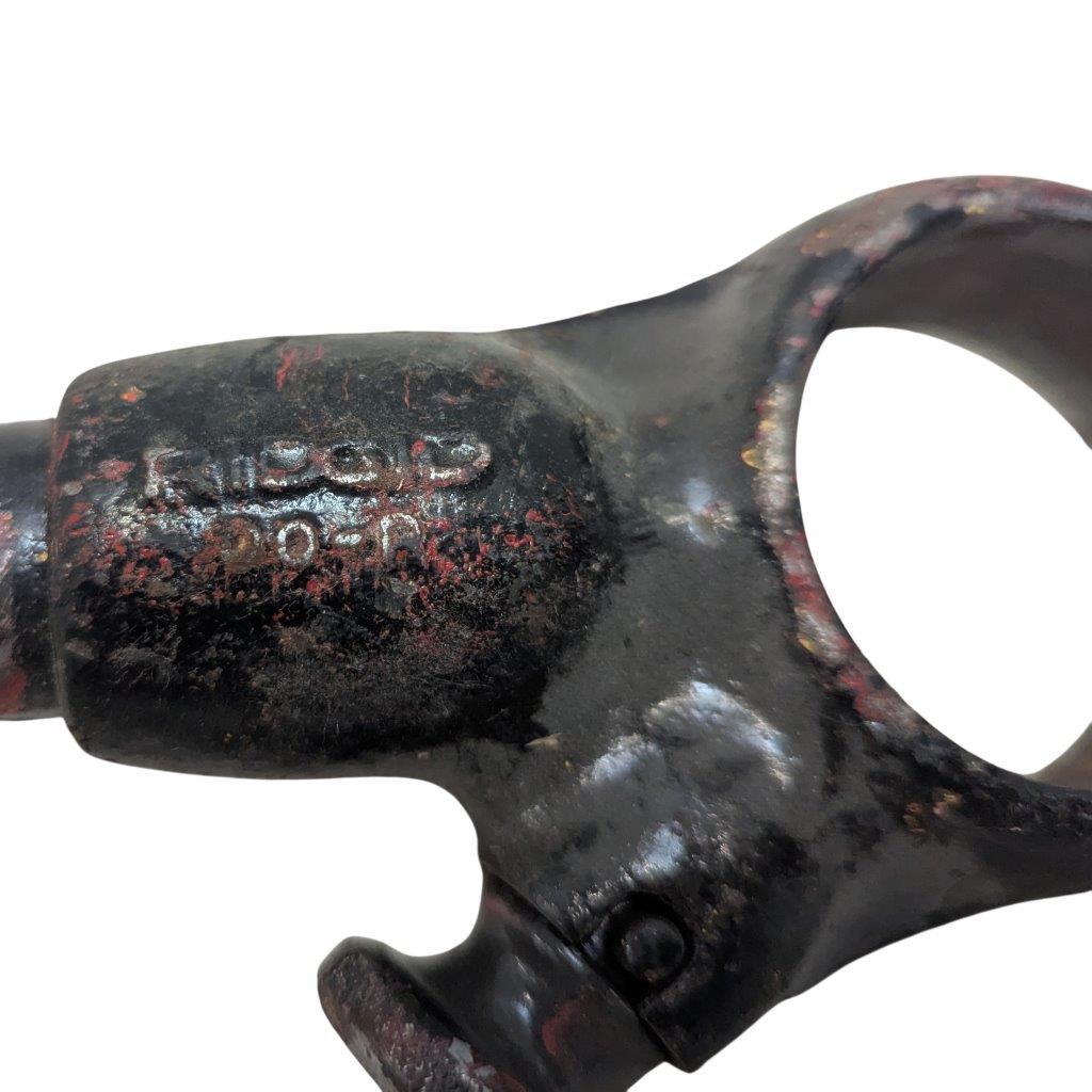 RIDGID-00-R_5 | Chicago HVAC tools and supplies Close-up of a heavily rusted black metal clamp with faded stamped letters on its surface.