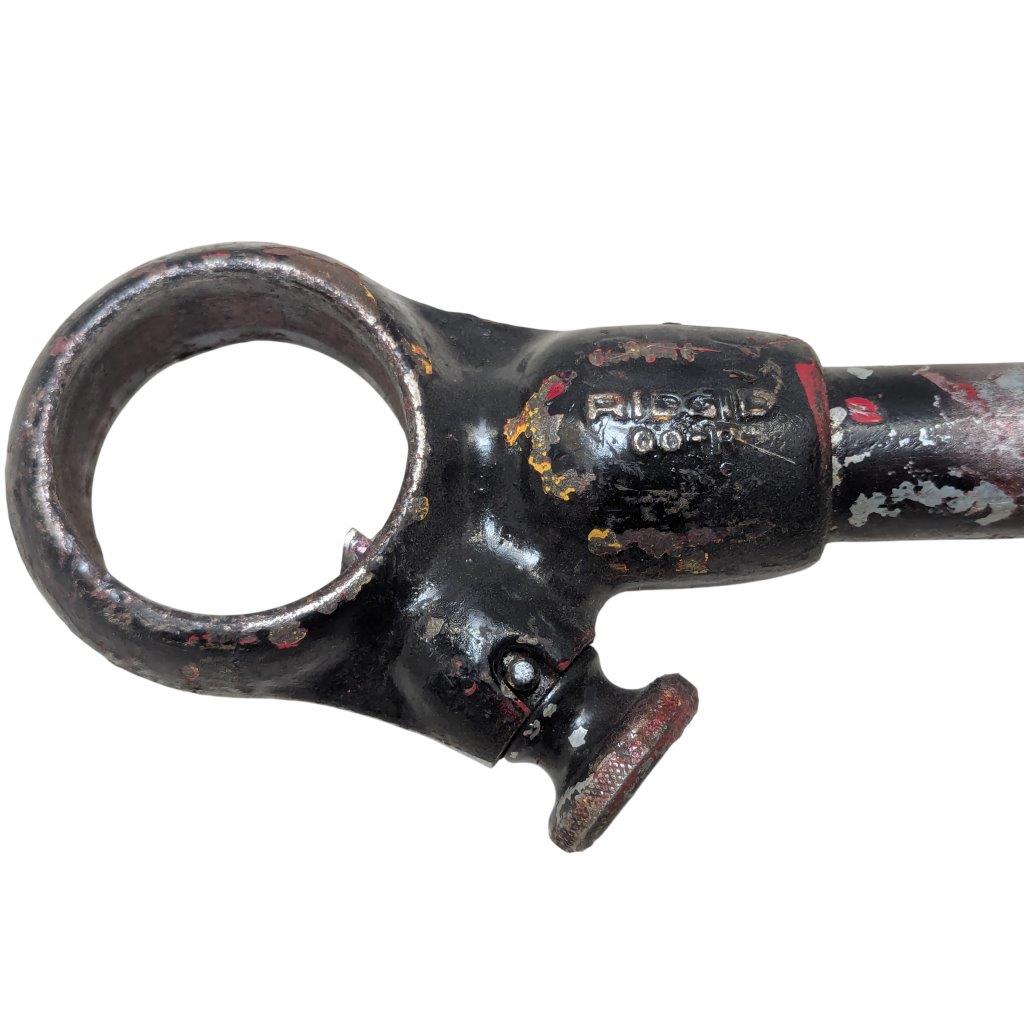RIDGID-00-R_7 | Chicago HVAC tools and supplies Close-up of a rusted black metal tool with a large circular ring on the left and a small adjustable knob, showing chipped paint and wear.