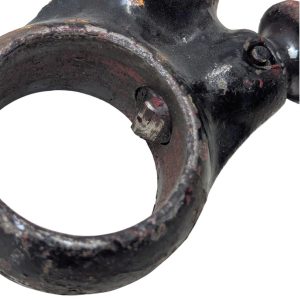 RIDGID-00-R_8 | Chicago HVAC tools and supplies Close-up of a rusted black metal ring attached to a heavy joint, with a protruding bolt and chipped paint.