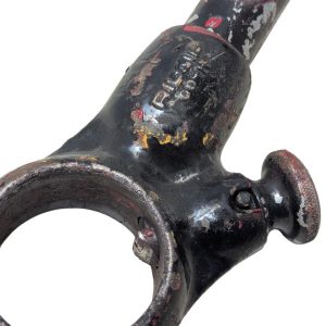 RIDGID-00-R_9 | Chicago HVAC tools and supplies Close-up of a worn, black-painted metal tool with a circular ring and a rounded knob, showing rust and chipped paint.