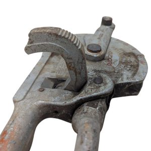 RIDGID-NO-378-Tube-Bender_11 | Chicago HVAC tools and supplies Close-up of a rusty vintage adjustable pipe wrench with serrated jaws and adjustment screw.