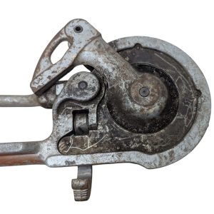 RIDGID-NO-378-Tube-Bender_9 | Chicago HVAC tools and supplies Close-up of a rusted vintage hand-cranked circular saw with guard and handle.