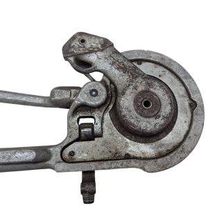 Ridgid-358-Model-Geared-Ratchet-Tube-Bender_5 | Chicago HVAC tools and supplies Close-up of a rusted vintage hand-cranked mechanical lever and circular gear housing, showing a worn metal ratchet mechanism.