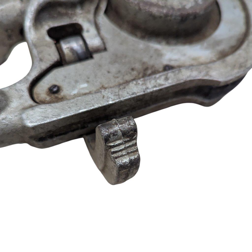 Ridgid-358-Model-Geared-Ratchet-Tube-Bender_7 | Chicago HVAC tools and supplies Close-up of a weathered metal clamp with a knurled, textured thumb screw.