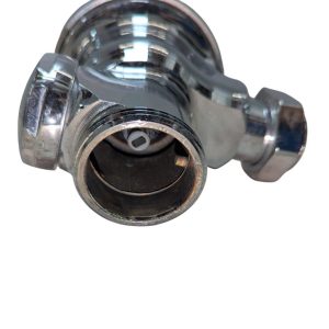 Close-up of a chrome faucet valve body with an exposed inner cartridge inside the opening