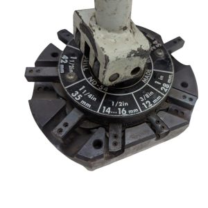 T-DRILL-ND-54-Tube-End-Notcher_12 | Chicago HVAC tools and supplies Circular drill index with size markings in inches and millimeters around a central, worn metal arbor; used to select drill sizes.