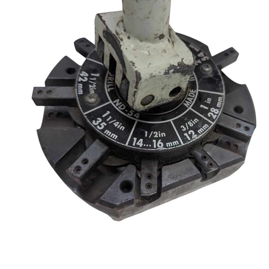 T-DRILL-ND-54-Tube-End-Notcher_12 | Chicago HVAC tools and supplies Circular drill index with size markings in inches and millimeters around a central, worn metal arbor; used to select drill sizes.