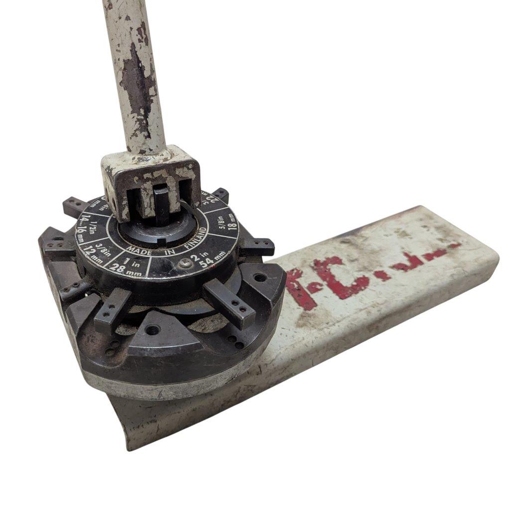 T-DRILL-ND-54-Tube-End-Notcher_14 | Chicago HVAC tools and supplies Close-up of a dirty rotary index dial with multiple protruding tabs, mounted on a metal bar showing wear and a Finnish-made stamp.