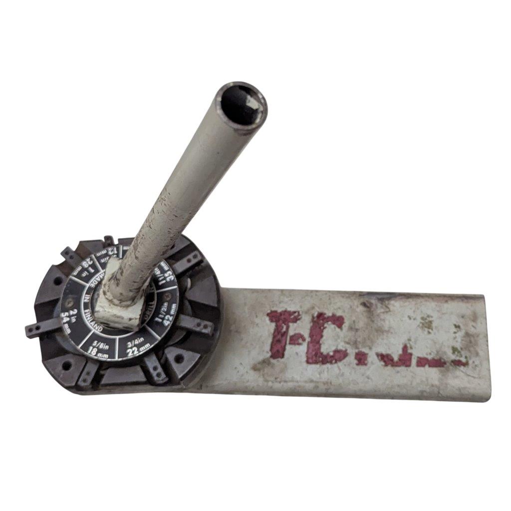 T-DRILL-ND-54-Tube-End-Notcher_3 | Chicago HVAC tools and supplies Worn metal adjustment lever: a cylindrical rod attached to a circular dial on a scratched base stamped TLC.